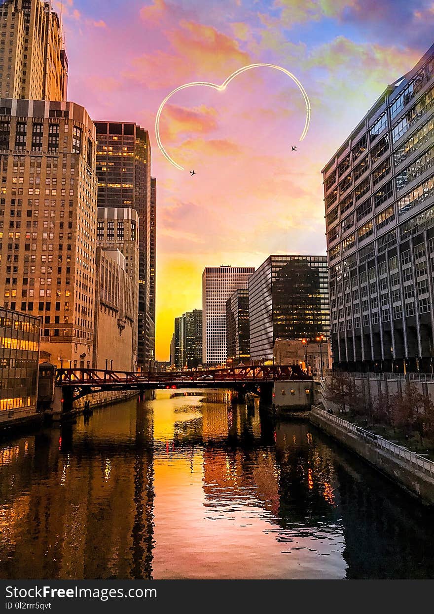 Two Black Aircrafts Above Buildings Golden Hour