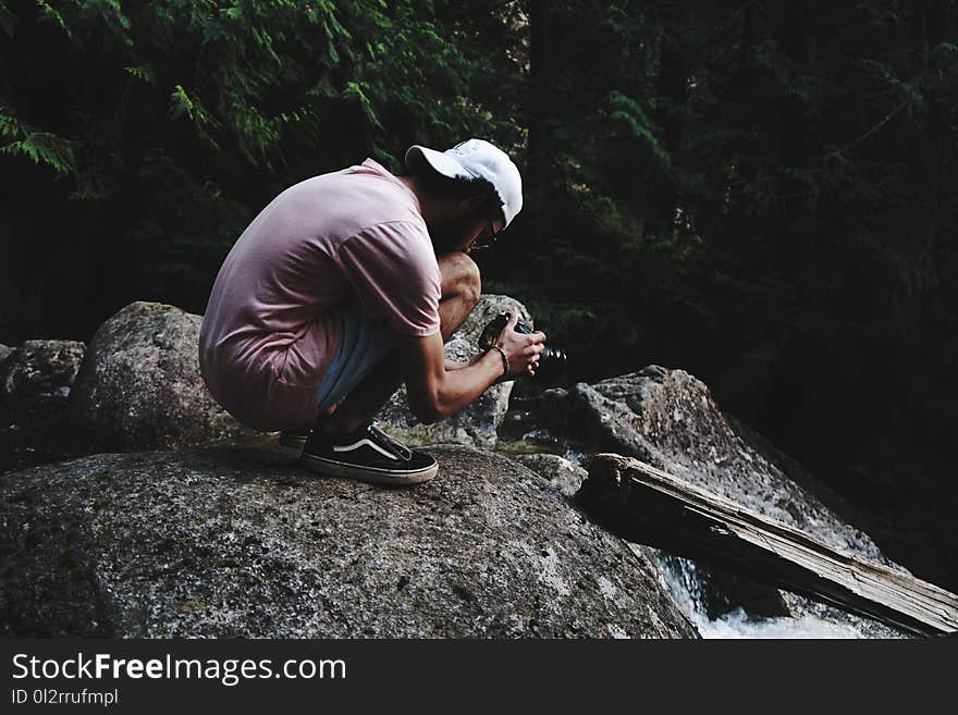 Man Wearing Pink Shirt Holding Dslr Camera