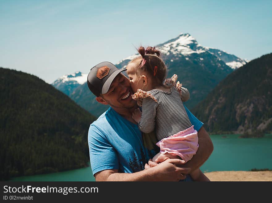 Man Carrying Her Daughter Smiling