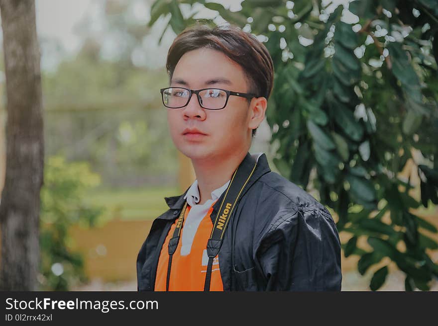 Man in Black Collared Top Posing for Photo