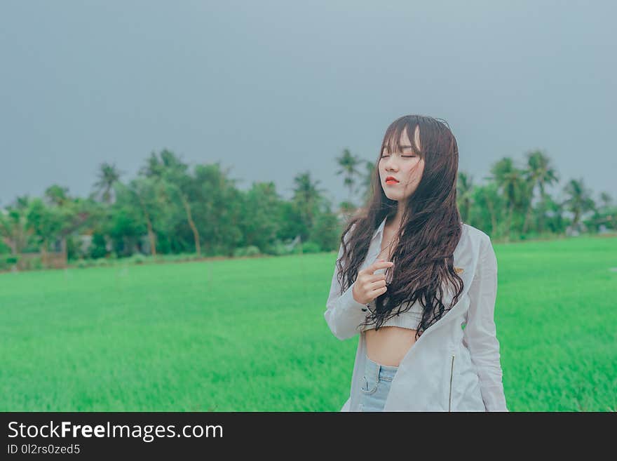 Woman Wearing Gray Cardigan on Green Grass