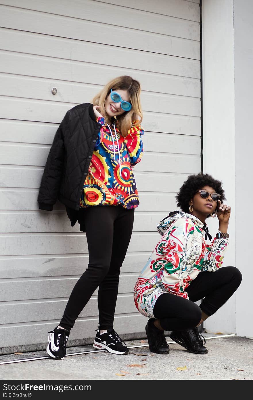 Women Wearing Multicolored Pullover Hoodie and Black Jacket