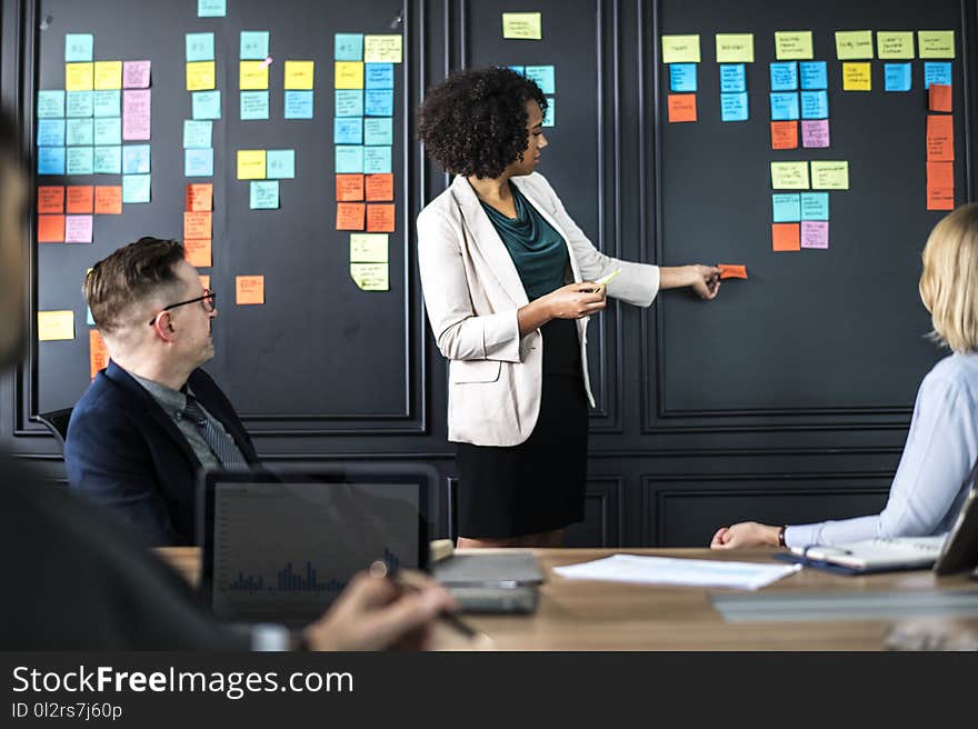 Woman Standing in Front of Sitting People