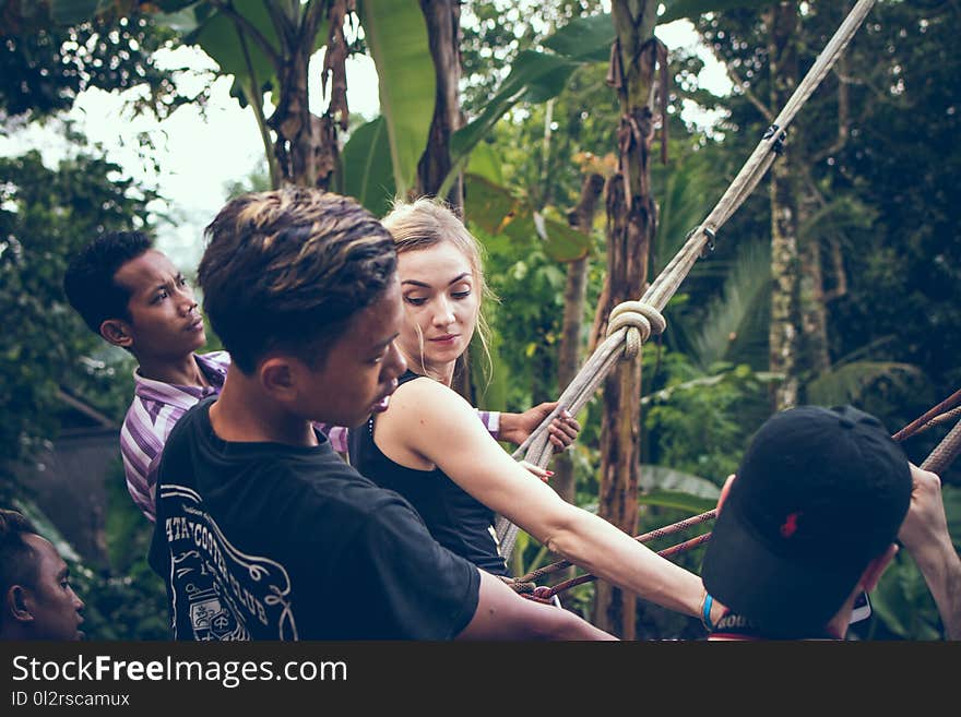 Blonde Haired Woman Wearing Black Tank Top Holding Rope