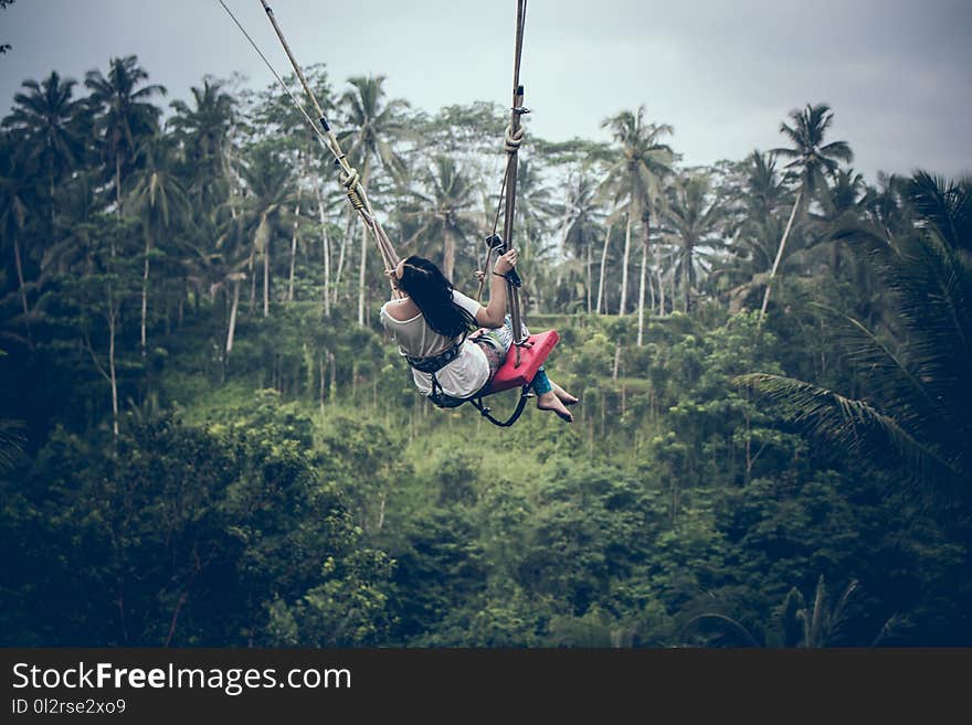 Black Haired Woman Riding a Swing