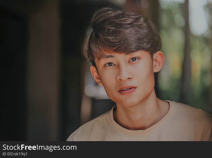 Selective-focus Photography of Man Wearing Beige Crew-neck Shirt