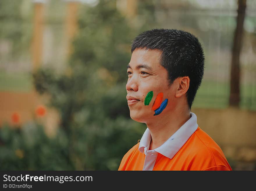 Man Wearing White and Orange Polo Shirt