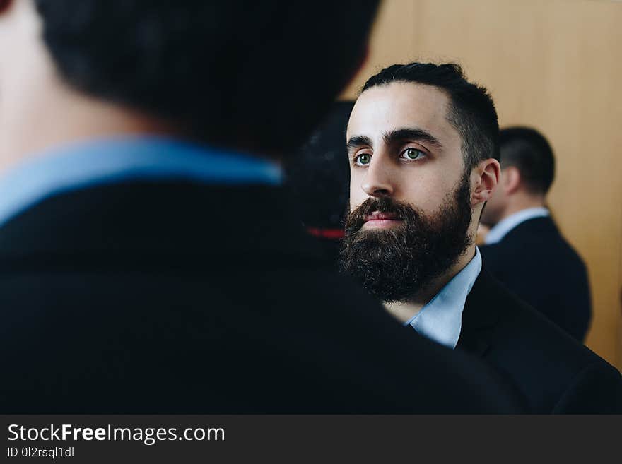 Man Wearing Black and Blue Suit