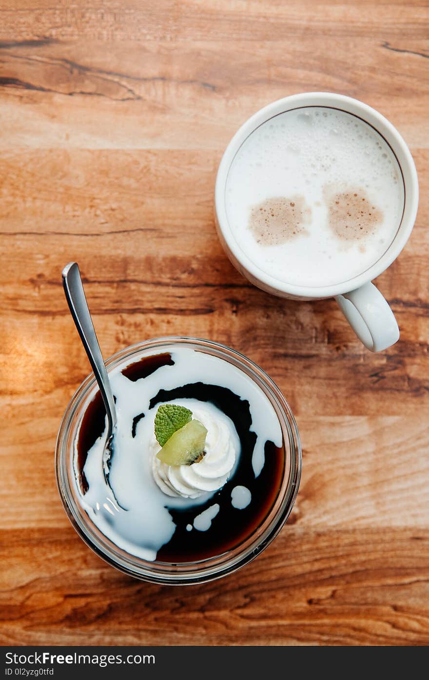 Creamy vanilla caramel pudding with Kiwi in glass cup and coffee