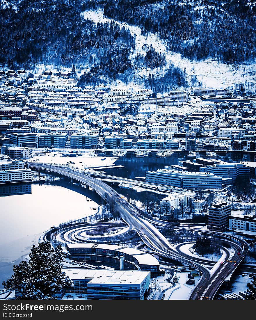 View from the mountains to Bergen in winter, city with roads, Norway