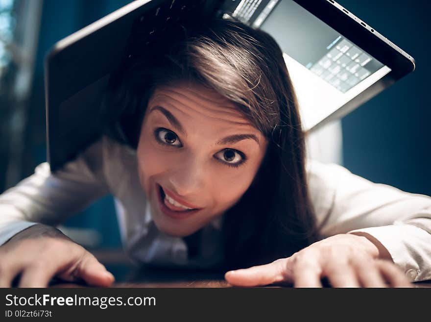 Close portrait of pretty girl lying on office table. Gorgeous female office assistant lying on table with her hands under her cheek with dreamy look on her face. Close portrait of pretty girl lying on office table. Gorgeous female office assistant lying on table with her hands under her cheek with dreamy look on her face.