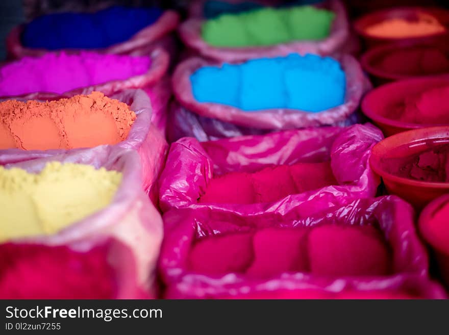 Colorful natural rangoli powders on street marker, close-up. Colorful natural rangoli powders on street marker, close-up