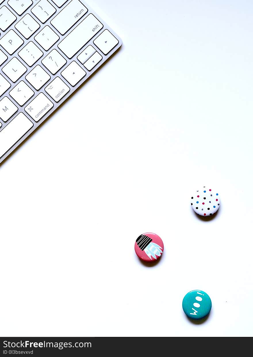 Flat-lay Photography of Three Buttons Near Keyboard