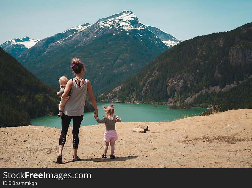 Mother and Children Walks Near Body of Water