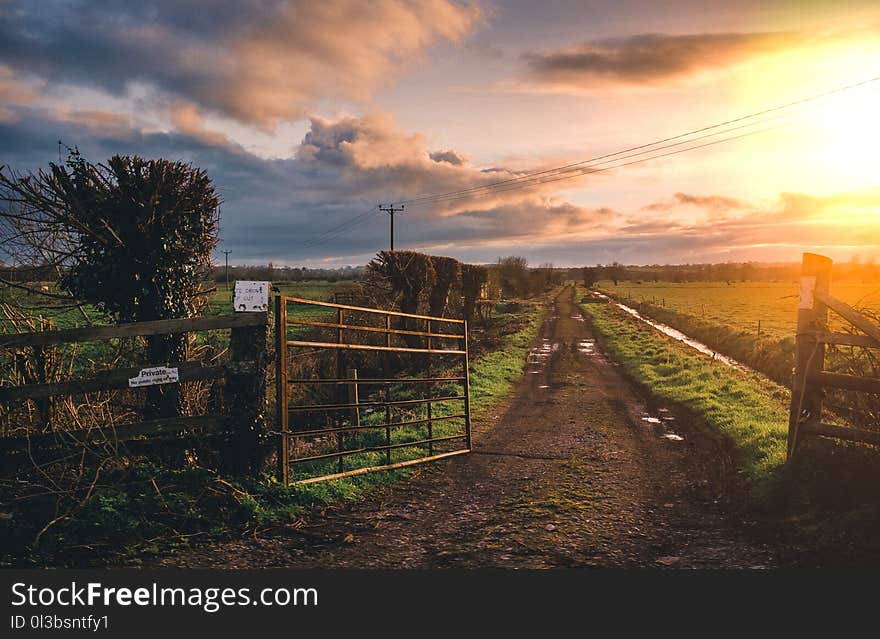 Brown Farm Gate and Green Grass Field