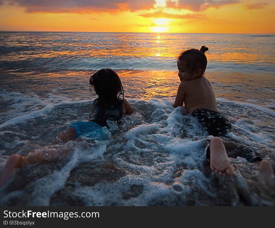 Photo of Two Girls in Beach during Golden Hour