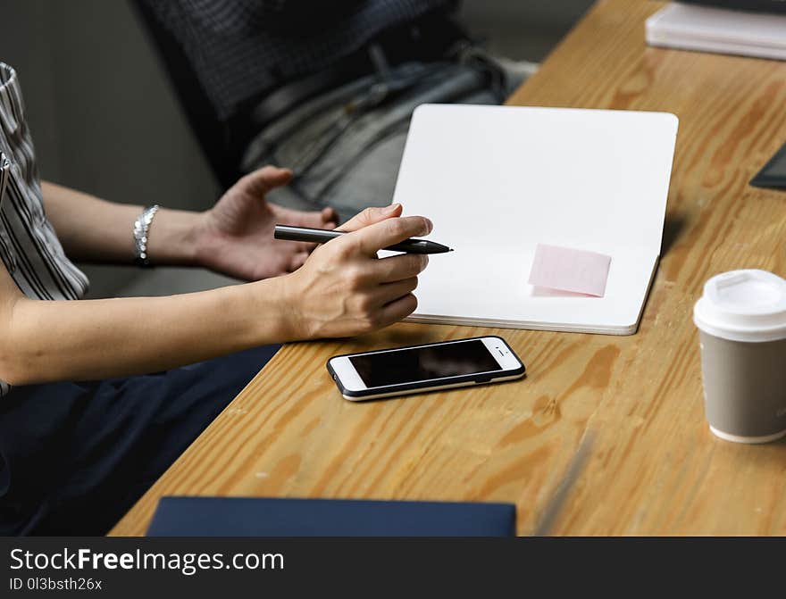 Person Holding Pen and Notebook