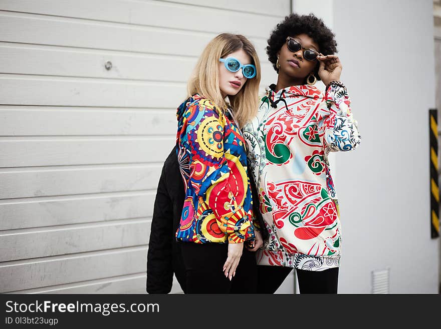 Two Women Standing Near Roller Shutter