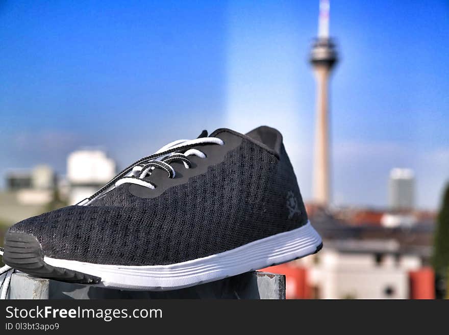 Unpaired of Black and White Lace-up Sneaker in Selective Focus Photography