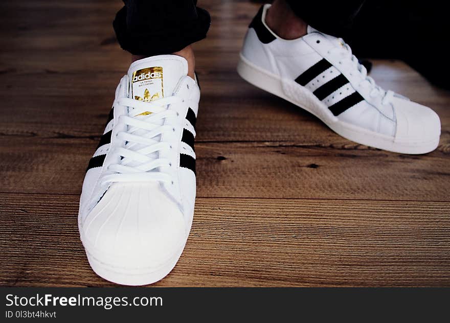 Pair of White-and-black Adidas Superstars