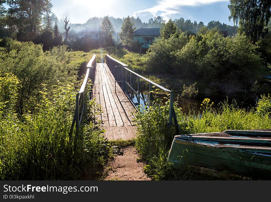 A Bridge Across A Small River In The Village