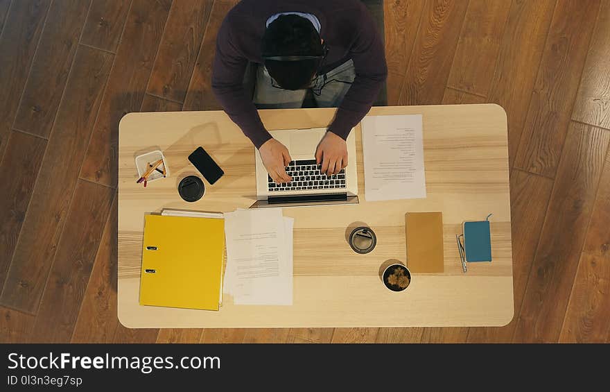 Young man working at a computer in a call centre. Top view