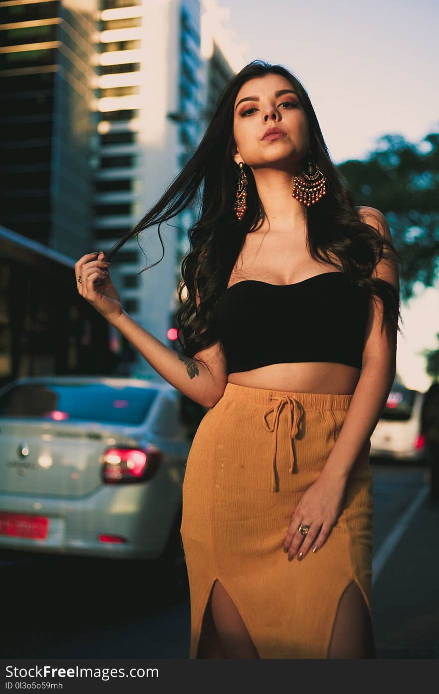 Woman Wearing Black Crop Top and Orange Skirt Standing