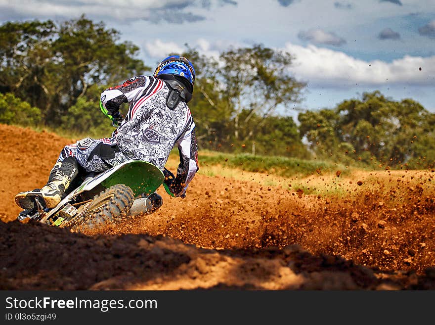 Man Riding Motocross Dirt Bike on Track