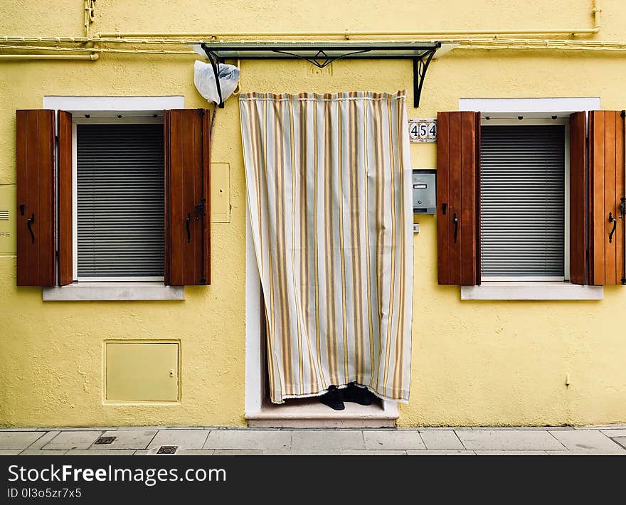 White and Brown Curtain on Yellow Wall