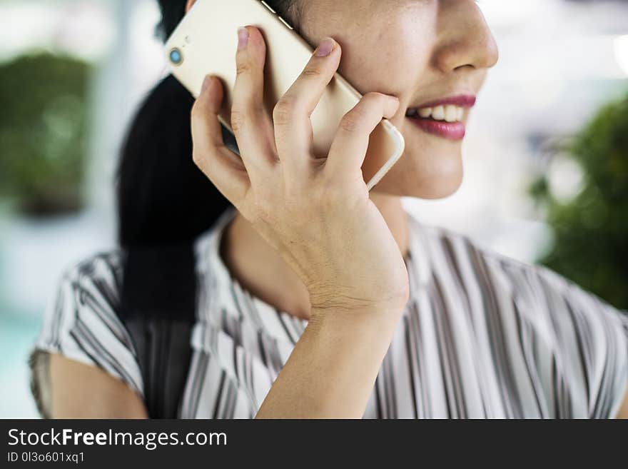 Shallow Focus Photography of Smiling Woman Holding Gold Iphone 7