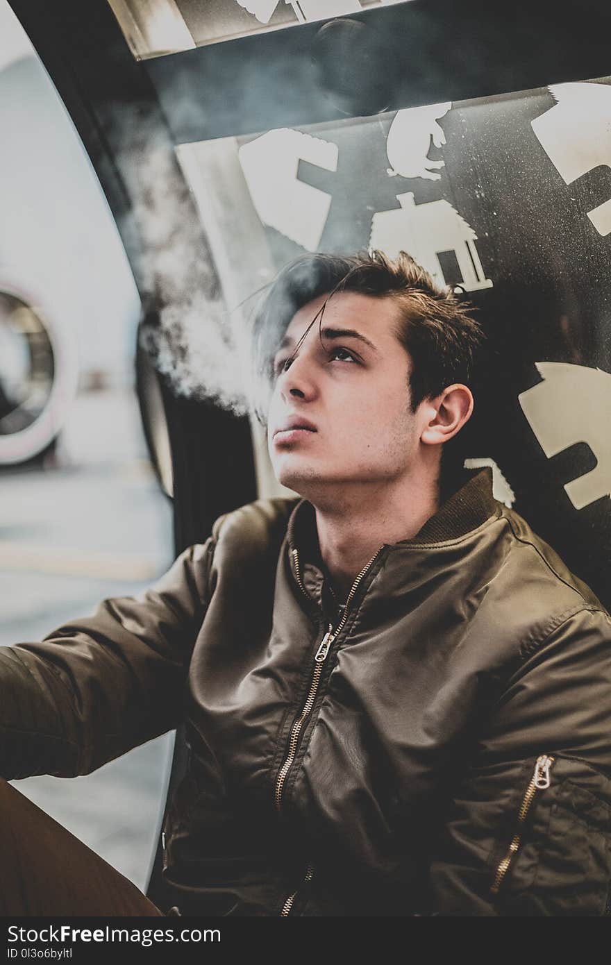 Man Wearing Brown Leather Zip-up Jacket Using Cigarette