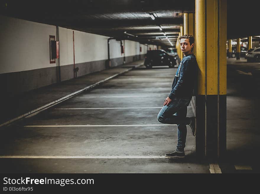 Man Leaning on Post