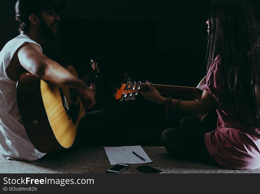 Man and Woman Playing Guitar