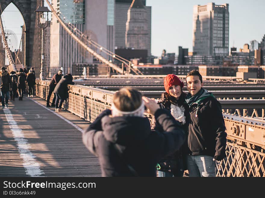 Man and Woman Standing Near Railings