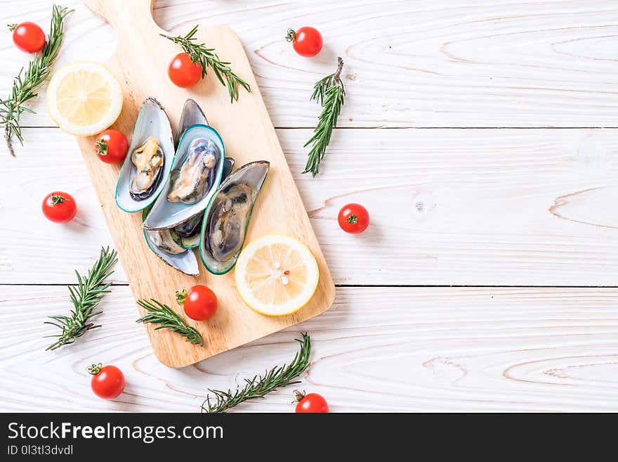 fresh mussels on wooden board