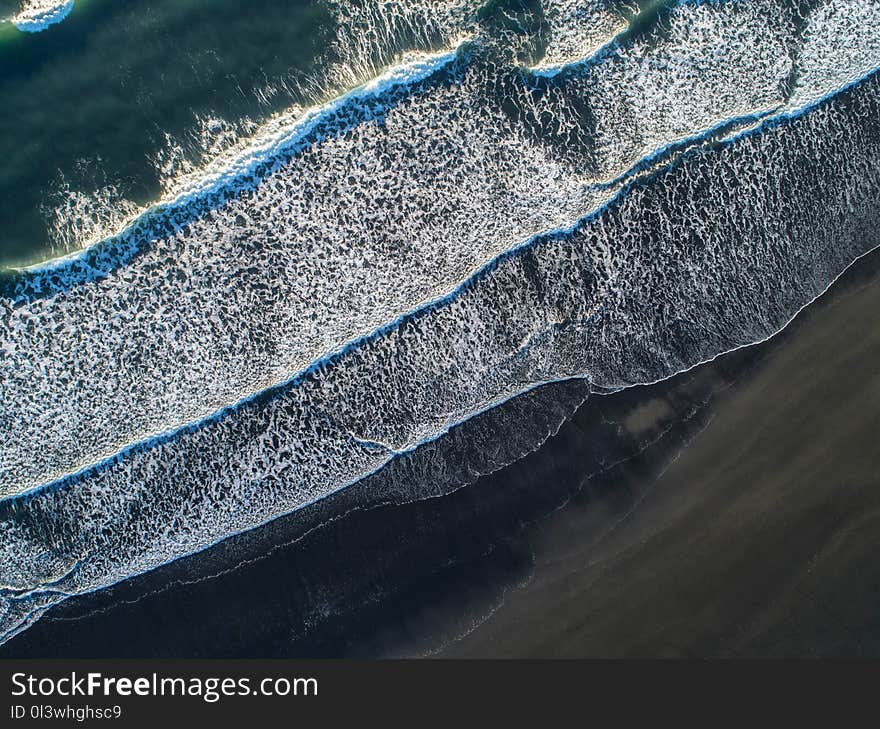 The black sand beach in Iceland. Sea aerial view and top view. Amazing nature, beautiful backgrounds and colors.