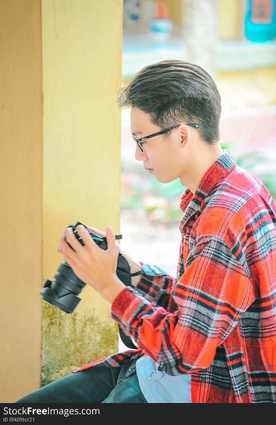 Photography of a Man Holding Black Camerar