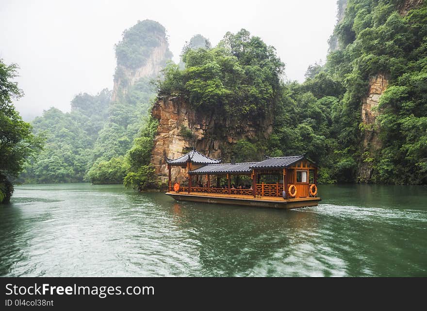 Baofeng Lake Boat Trip in a rainy day with clouds and mist at Wulingyuan, Zhangjiajie National Forest Park, Hunan Province, China, Asia.