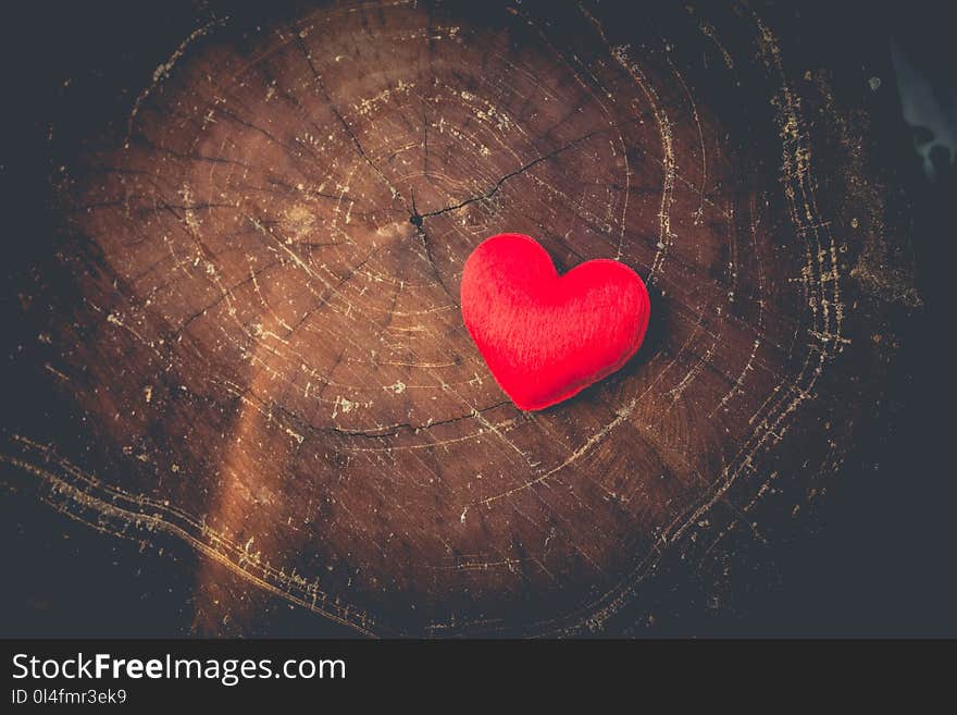 Red heart shape on wooden board. Love concept.