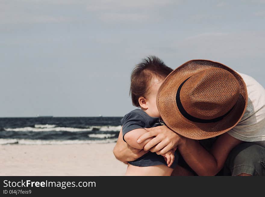 Photo of Person Holding His Baby