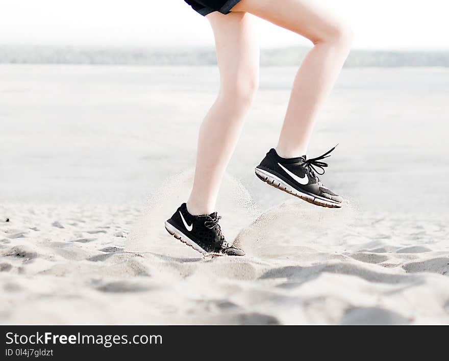 Photo of Woman Wearing Pair of Black Nike Running Shoes