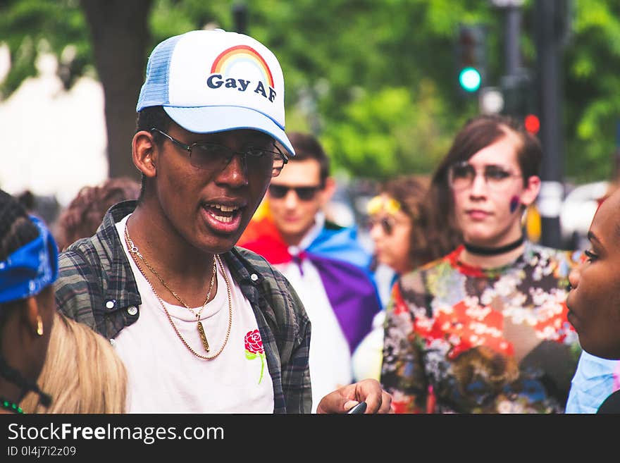 Man With White Crew-neck Shirt Beside Woman With Multicolored Shirt at Daytime