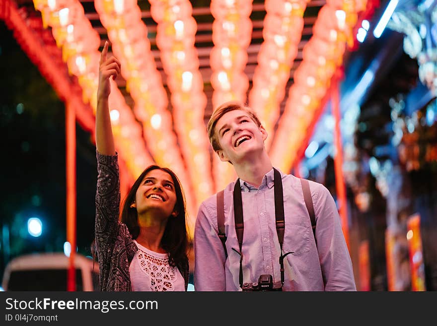 Photo of Man and Woman Looking Up