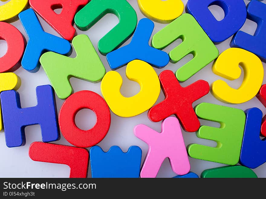 Colorful alphabet letter blocks scattered randomly on white background. Colorful alphabet letter blocks scattered randomly on white background