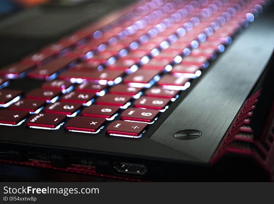 A red-black gaming laptop with a luminous keyboard