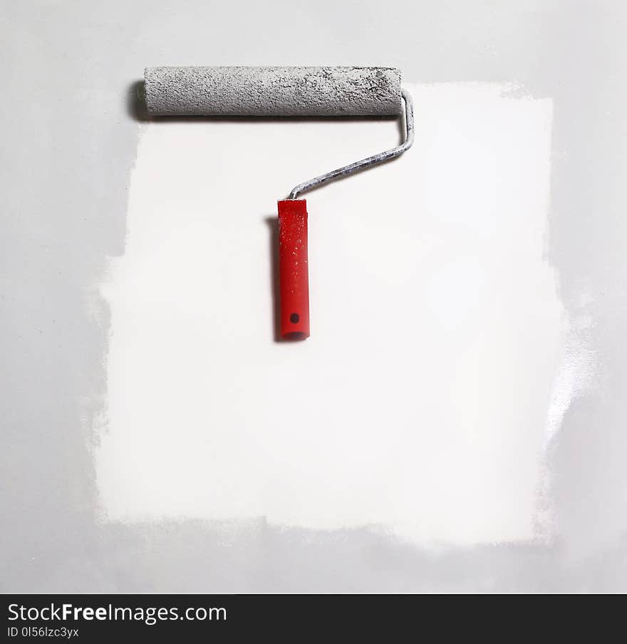 Paint roller painting on white paper.background.place for text