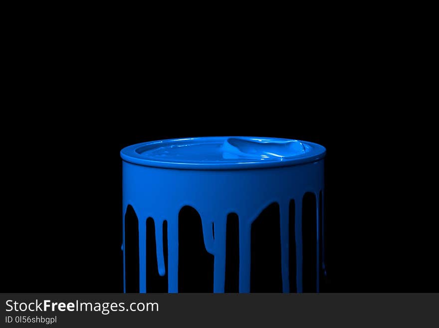 Colorful paint leaking down over the part of metal bucket. Isolated over black background. Colorful paint leaking down over the part of metal bucket. Isolated over black background