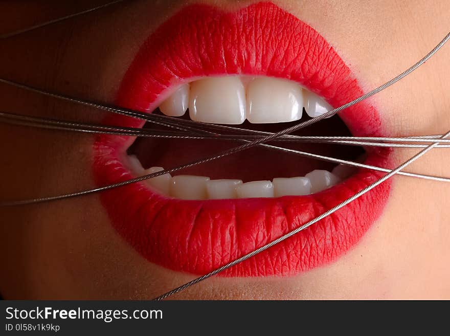 Closeup Photo of a Woman With Gray Cables on His Mouth