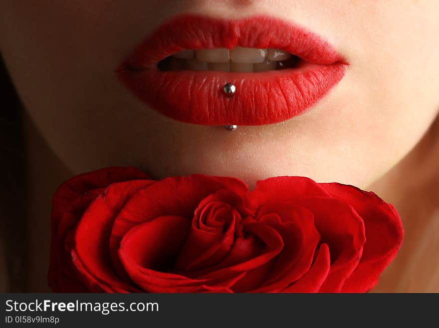 Woman Wearing Red Lipstick Near Red Rose