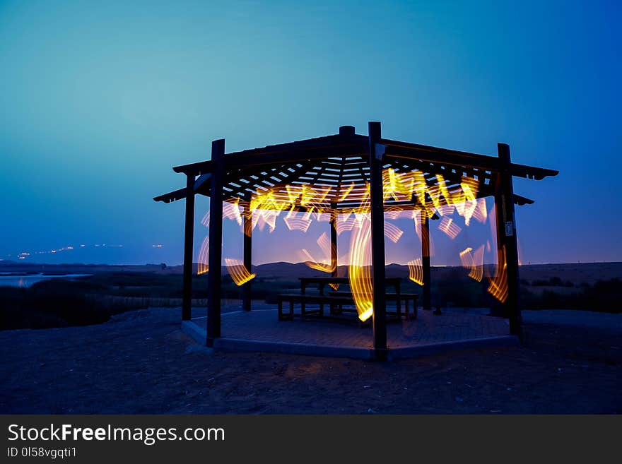 Brown Wooden Gazebo Near Sea